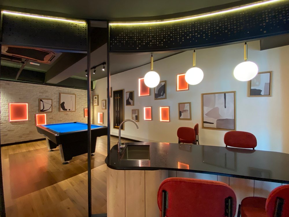 M Adora games room with pool table and bar counter